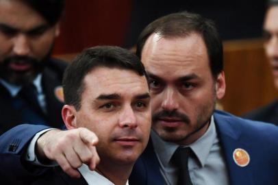 Brazilian Senator for Rio de Janeiro Flavio Bolsonaro (L) and Councillor of Rio de Janeiro Carlos Bolsonaro attend their father Brazilian President-elect Jair Bolsonaro's ceremony to receive a diploma that certifies he can take office as president, at the TSE in Brasilia, on December 10, 2018. - Bolsonaro takes office on January 1, 2019. (Photo by EVARISTO SA / AFP)