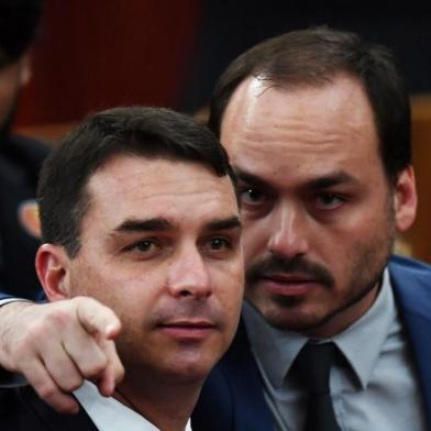 Brazilian Senator for Rio de Janeiro Flavio Bolsonaro (L) and Councillor of Rio de Janeiro Carlos Bolsonaro attend their father Brazilian President-elect Jair Bolsonaro's ceremony to receive a diploma that certifies he can take office as president, at the TSE in Brasilia, on December 10, 2018. - Bolsonaro takes office on January 1, 2019. (Photo by EVARISTO SA / AFP)