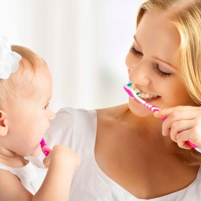 mother and daughter baby girl brushing their teeth togetherImportação Donnahttp://cdn.re