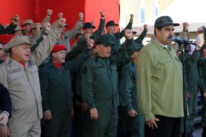 Handout picture released by the Venezuelan presidency showing Venezuelan President Nicolas Maduro (R) delivering a speech during a military parade to commemorate the anniversary of the death in 1830 of The Liberator Simon Bolivar, at the Military Academy in Caracas on December 17, 2018. (Photo by JHONN ZERPA / Venezuelan Presidency / AFP) / RESTRICTED TO EDITORIAL USE - MANDATORY CREDIT AFP PHOTO / VENEZUELAN PRESIDENCY / JHONN ZERPA - NO MARKETING NO ADVERTISING CAMPAIGNS - DISTRIBUTED AS A SERVICE TO CLIENTS