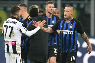 Inter Milan's Belgian midfielder Radja Nainggolan (R) and Udinese's midfielder Marco D'Alessandro tap hands at the end of the Italian Serie A football match Inter Milan vs Udinese on December 15, 2018 at the San Siro stadium in Milan. 