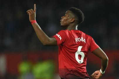  Manchester Uniteds French midfielder Paul Pogba celebrates scoring their third goal during the English Premier League football match between Manchester United and Huddersfield Town at Old Trafford in Manchester, north west England, on December 26, 2018. (Photo by Oli SCARFF / AFP) / RESTRICTED TO EDITORIAL USE. No use with unauthorized audio, video, data, fixture lists, club/league logos or live services. Online in-match use limited to 120 images. An additional 40 images may be used in extra time. No video emulation. Social media in-match use limited to 120 images. An additional 40 images may be used in extra time. No use in betting publications, games or single club/league/player publications. / Editoria: SPOLocal: ManchesterIndexador: OLI SCARFFSecao: soccerFonte: AFPFotógrafo: STR