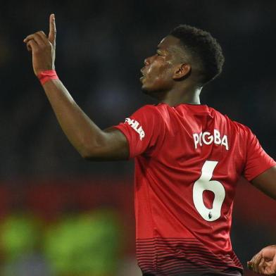  Manchester Uniteds French midfielder Paul Pogba celebrates scoring their third goal during the English Premier League football match between Manchester United and Huddersfield Town at Old Trafford in Manchester, north west England, on December 26, 2018. (Photo by Oli SCARFF / AFP) / RESTRICTED TO EDITORIAL USE. No use with unauthorized audio, video, data, fixture lists, club/league logos or live services. Online in-match use limited to 120 images. An additional 40 images may be used in extra time. No video emulation. Social media in-match use limited to 120 images. An additional 40 images may be used in extra time. No use in betting publications, games or single club/league/player publications. / Editoria: SPOLocal: ManchesterIndexador: OLI SCARFFSecao: soccerFonte: AFPFotógrafo: STR