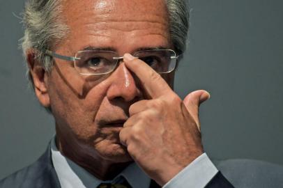 The new Brazilian Economy Minister, Paulo Guedes takes office during a ceremony in Brasilia, on January 02, 2019. - Brazl's President Jair Bolsonaro has appointed a free-marketeer, Paulo Guedes, as economy minister to push through reforms to bring down Brazil's swelling debt, mainly through privatizations, tax changes and encouraging foreign investment. (Photo by CARL DE SOUZA / AFP)