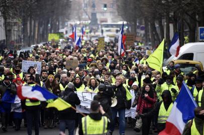 People march during a yellow vest (gilets jaunes) anti-government demonstration in the northern city of Lille on December 29, 2018. - Police fired tear gas at yellow vest demonstrators in Paris on December 29 but the turnout for round seven of the popular protests that have rocked France appeared low. The yellow vests (gilets jaunes) movement in France originally started as a protest about planned fuel hikes but has morphed into a mass protest against Presidents policies and top-down style of governing. (Photo by FRANCOIS LO PRESTI / AFP)