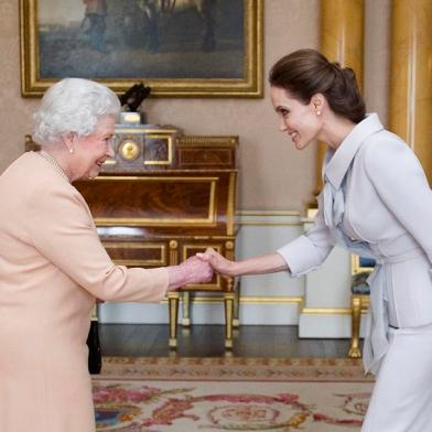 US actress Angelina Jolie (R) is presented with the Insignia of an Honorary Dame Grand Cro