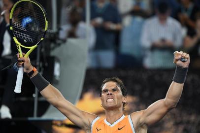 Spain's Rafael Nadal celebrates his victory against Frances Tiafoe of the US during their men's singles quarter-final match on day nine of the Australian Open tennis tournament in Melbourne on January 22, 2019. (Photo by SAEED KHAN / AFP) / -- IMAGE RESTRICTED TO EDITORIAL USE - STRICTLY NO COMMERCIAL USE --