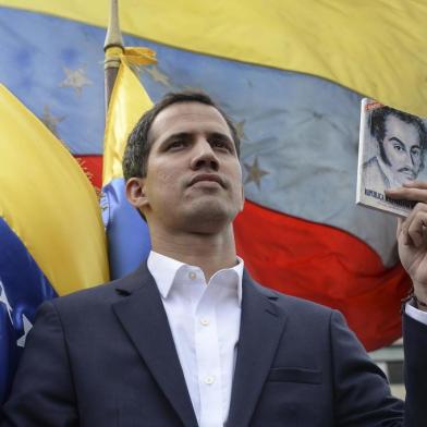 Venezuela's National Assembly head Juan Guaido declares himself the country's "acting president" during a mass opposition rally against leader Nicolas Maduro, on the anniversary of a 1958 uprising that overthrew military dictatorship in Caracas on January 23, 2019. - Moments earlier, the loyalist-dominated Supreme Court ordered a criminal investigation of the opposition-controlled legislature. "I swear to formally assume the national executive powers as acting president of Venezuela to end the usurpation, (install) a transitional government and hold free elections," said Guaido as thousands of supporters cheered. (Photo by Federico PARRA / AFP)