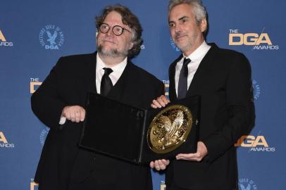 HOLLYWOOD, CALIFORNIA - FEBRUARY 02: Guillermo del Toro (L) and 2018 DGA Feature Film Award winner for Roma Alfonso Cuaron pose in the press room during the 71st Annual Directors Guild Of America Awards at The Ray Dolby Ballroom at Hollywood & Highland Center on February 02, 2019 in Hollywood, California.   Frazer Harrison/Getty Images/AFP