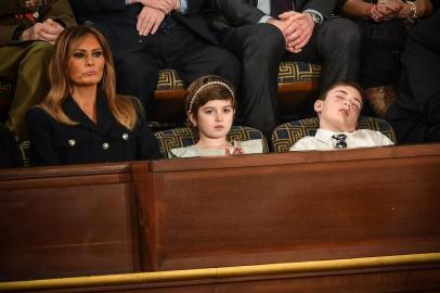 US First lady Melania Trump (L) with Grace Eline and Joshua Trump, special guests of President Donald Trump, look during of the State of the Union address at the US Capitol on February 5, 2019 in Washington, DC. (Photo by MANDEL NGAN / AFP)