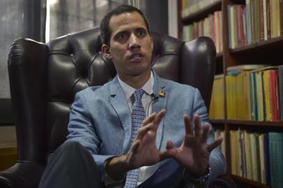 The president of Venezuelas National Assembly and self-proclaimed acting president Juan Guaido speaks during an exclusive interview with AFP in Caracas on February 8, 2019. - Venezuelas self-proclaimed acting leader Juan Guaido refused to rule out Friday the possibility of authorizing a US intervention to help force President Nicolas Maduro from power and alleviate a humanitarian crisis. (Photo by YURI CORTEZ / AFP)