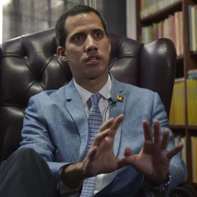 The president of Venezuelas National Assembly and self-proclaimed acting president Juan Guaido speaks during an exclusive interview with AFP in Caracas on February 8, 2019. - Venezuelas self-proclaimed acting leader Juan Guaido refused to rule out Friday the possibility of authorizing a US intervention to help force President Nicolas Maduro from power and alleviate a humanitarian crisis. (Photo by YURI CORTEZ / AFP)