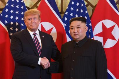 US President Donald Trump (L) shakes hands with North Koreas leader Kim Jong Un before a meeting at the Sofitel Legend Metropole hotel in Hanoi on February 27, 2019. (Photo by Saul LOEB / AFP)