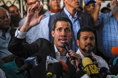 Venezuelan opposition leader and self-proclaimed acting president Juan Guaido (C) gestures as he speaks during a press conference after a meeting with union leaders in Caracas on March 5, 2019. - Juan Guaido calls himself a survivor, and he proved that by defying the threat of arrest to make a triumphant return to Venezuela on Monday. Since declaring himself interim president in a challenge to Nicolas Maduro on January 23, Guaido has shown skill in his power struggle with the socialist leader. (Photo by Federico PARRA / AFP)