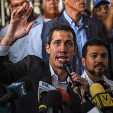 Venezuelan opposition leader and self-proclaimed acting president Juan Guaido (C) gestures as he speaks during a press conference after a meeting with union leaders in Caracas on March 5, 2019. - Juan Guaido calls himself a survivor, and he proved that by defying the threat of arrest to make a triumphant return to Venezuela on Monday. Since declaring himself interim president in a challenge to Nicolas Maduro on January 23, Guaido has shown skill in his power struggle with the socialist leader. (Photo by Federico PARRA / AFP)