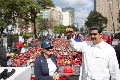 This handout photo released by Miraflores Presidential Palace press office shows Venezuelas President Nicolas Maduro (R) next to first lady Cilia Flores (L) during a rally at the Miraflores Presidential Palace in Caracas, Venezuela on March 9, 2019. - Maduro stated that a new cybernetics attack prevented electricity reconnection, following a massive blackout on March 7. (Photo by HO / Venezuelan Presidency / AFP) / RESTRICTED TO EDITORIAL USE - MANDATORY CREDIT AFP PHOTO /  PRESIDENCIA VENEZUELA - NO MARKETING - NO ADVERTISING CAMPAIGNS - DISTRIBUTED AS A SERVICE TO CLIENTS