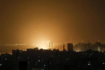  The sky above buildings on the Gaza Strip glows orange during an Israeli air strike in Gaza city late on March 14, 2019. - The Israeli military said on March 15 that it had carried out strikes in Gaza in response to earlier rocket fire from the Palestinian enclave. We have just started striking terror sites in Gaza, the Israel Defense Forces said on Twitter. (Photo by MAHMUD HAMS / AFP)Editoria: WARLocal: Gaza CityIndexador: MAHMUD HAMSSecao: conflict (general)Fonte: AFPFotógrafo: STF