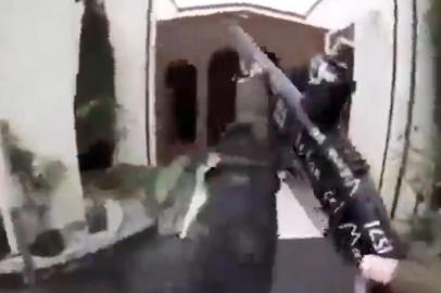 This image grab from a self-shot video that was streamed on Facebook Live on March 15, 2019 by the man who was involved in two mosque shootings in Christchurch shows the man holding a gun as he enters the Masjid al Noor mosque. - A right-wing extremist armed with semi-automatic weapons rampaged through two mosques in the quiet New Zealand city of Christchurch during afternoon prayers on March 15, killing 49 worshippers and wounding dozens more. (Photo by Handout / HANDOUT / AFP) / -----EDITORS NOTE --- RESTRICTED TO EDITORIAL USE - MANDATORY CREDIT AFP PHOTO / HANDOUT - NO MARKETING - NO ADVERTISING CAMPAIGNS - DISTRIBUTED AS A SERVICE TO CLIENTS - NO ARCHIVES