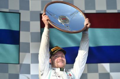  Mercedes Finnish driver Valtteri Bottas celebrates on the podium after winning the Formula One Australian Grand Prix in Melbourne on March 17, 2019. (Photo by PETER PARKS / AFP) / -- IMAGE RESTRICTED TO EDITORIAL USE - STRICTLY NO COMMERCIAL USE --Editoria: SPOLocal: MelbourneIndexador: PETER PARKSSecao: motor racingFonte: AFPFotógrafo: STF