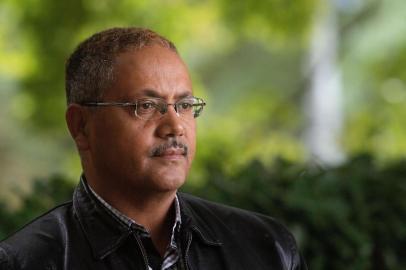 Abdul Kadir Ababora an Ethiopian living in New Zealand and who was in the Dean Street mosque when worshipers were gunned down on March 15, poses in Christchurch on March 17, 2019. - The death toll from horrifying shootings at two mosques in New Zealand rose to 50, police said Sunday, as Christchurch residents flocked to memorial sites and churches across the city to lay flowers and mourn the victims. (Photo by Marty MELVILLE / AFP)