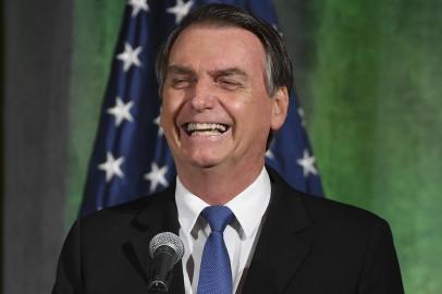 Brazils President Jair Bolsonaro smiles during a discussion on US-Brazil relations at the US Chamber of Commerce in Washington, DC on March 18, 2019. (Photo by MANDEL NGAN / AFP) 