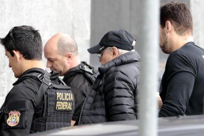  Former Brazilian Economy Minister Guido Mantega (2-R) is escorted by Federal Police agents, after being arrested in Sao Paulo, Brazil on September 22, 2016. Brazilian police Thursday arrested Guido Mantega, a former finance minister under presidents Lula da Silva and Dilma Rousseff, as part of the investigation into the vast Petrobras corruption scheme, media reported. Mantega, who was an important figure in the leftist Workers Party, was arrested at a Sao Paulo hospital where his wife had undergone surgery.Miguel Schincariol / AFPEditoria: WARLocal: Sao PauloIndexador: MIGUEL SCHINCARIOLSecao: governmentFonte: AFPFotógrafo: STR