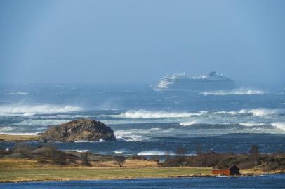 The cruise ship Viking Sky is pictured on March 23, 2019 near the west coast of Norway at Hustadvika near Romsdal. - Emergency services said on March 23, 2019 they were airlifting 1,300 passengers off a cruise ship off the Norwegian coast.The Viking Sky cruise ship sent an SOS message due to engine problems in bad weather, southern Norways rescue centre said on Twitter, while police reported the passengers would be evacuated by helicopter. (Photo by Frank Einar VATNE / NTB Scanpix / AFP) / Norway OUT