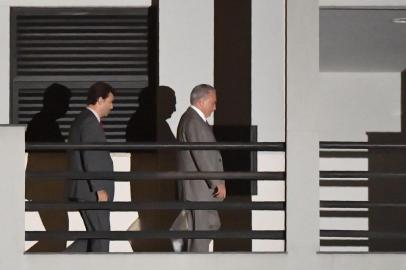 Brazils former president (2016-2018) Michel Temer (R) leaves the Federal Police headquarters in Rio de Janeiro, Brazil, on March 25, 2019, after a Brazilian judge ordered his immediate release, days after he was detained on allegations of being the leader of a criminal organization. - Temer, who was arrested Thursday in Sao Paulo and transferred to Rio de Janeiro, is the second ex-president of the Latin American country to be caught up in a sprawling, years-long anti-corruption probe called Car Wash that has claimed scores of political and corporate scalps. The preventative detention of Temer, the 78-year-old predecessor of the current far-right President Jair Bolsonaro, had no legal justification, judge Antonio Ivan Athie said in the ruling. (Photo by MAURO PIMENTEL / AFP)