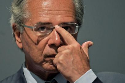 The new Brazilian Economy Minister, Paulo Guedes takes office during a ceremony in Brasilia, on January 02, 2019. - Brazl's President Jair Bolsonaro has appointed a free-marketeer, Paulo Guedes, as economy minister to push through reforms to bring down Brazil's swelling debt, mainly through privatizations, tax changes and encouraging foreign investment. (Photo by CARL DE SOUZA / AFP)