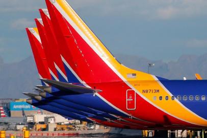 (FILES) In this file photo taken on March 13, 2019 a group of Southwest Airlines Boeing 737 MAX 8 aircraft sit on the tarmac at Phoenix Sky Harbor International Airport in Phoenix, Arizona. The United States has followed countries around the world and has grounded all Boeing 737 Max 8 aircraft. - A Boeing 737 MAX aircraft operated by Southwest Airlines made an emergency landing on March 26, 2019, after experiencing an engine problem as it was being ferried from Florida to California, the US Federal Aviation Agency said. The aircraft returned and landed safely in Orlando, the FAA said in a statement, adding that no passengers were on board the aircraft, which was being transferred to Victorville, California, for storage. (Photo by Ralph Freso / GETTY IMAGES NORTH AMERICA / AFP)