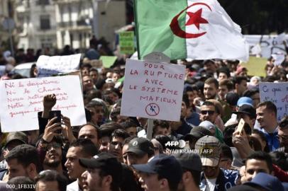 Algerian students raise banners and placards as they take part in a demonstraion against the current government, in the capital Algiers, on April 2, 2019.