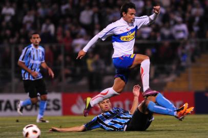 CHILE, Santiago : Marcelo Canete Cañete (jumping) of Universidad Catolica vies for the ball with Rodolfo of Gremio during their Copa Libertadores 2011 football match at the San Carlos de Apoquindo stadium in Santiago on May 4, 2011. AFP PHOTO/Claudio SANTANA