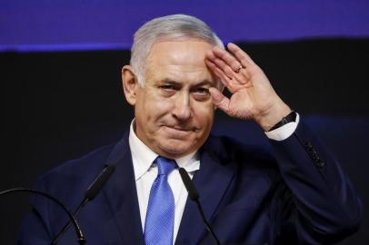 Israeli Prime Minister Benjamin Netanyahu gestures as he addresses supporters at his Likud Party headquarters in the Israeli coastal city of Tel Aviv on election night early on April 10, 2019. (Photo by Thomas COEX / AFP)