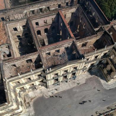 Aerial view of Rio de Janeiros treasured National Museum, one of Brazils oldest, on September 3, 2018, a day after a massive fire ripped through the building. The majestic edifice stood engulfed in flames as plumes of smoke shot into the night sky, while firefighters battled to control the blaze that erupted around 2230 GMT. Five hours later they had managed to smother much of the inferno that had torn through hundreds of rooms, but were still working to extinguish it completely. / AFP PHOTO / Mauro Pimentel