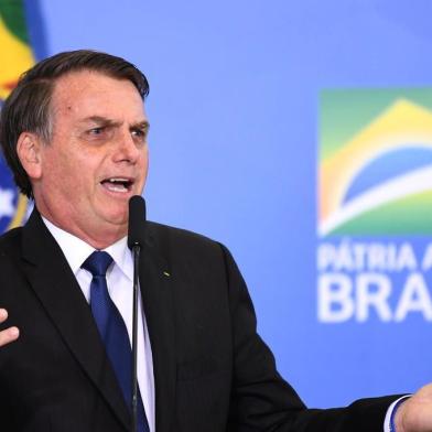 Brazilian President Jair Bolsonaro talks during the signing ceremony of the decree that facilitates to own, carry and import weapons, at the Planalto Palace in Brasilia, on May 7, 2019. (Photo by EVARISTO SA / AFP)