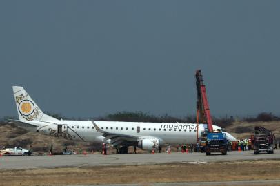 A general view shows a Myanmar National Airlines passenger plane after an emergency landing at Mandalay international airport on May 12, 2019. A Myanmar pilot saved the day after his aircraft's landing gear failed, forcing the jet into an emergency landing with no front wheels on on May 12, an official said.STR / AFP