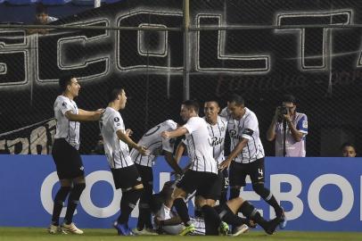 Paraguays Libertad player Matias Espinoza (bottom) celebrates with teammates after scoring against Argentinas Rosario Central during their Copa Libertadores football match at Defensores del Chaco stadium in Asuncion, Paraguay, on April 4, 2019. (Photo by NORBERTO DUARTE / AFP)