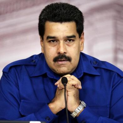 Venezuelan President Nicolas Maduro speaks during a press conference with foreign media in Caracas on December 30, 2013.  AFP PHOTO/JUAN BARRETO