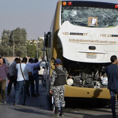 A picture taken on May 19, 2019, shows a bus damaged during a bomb blast near Egypts famed Giza pyramids. - A bomb blast hit a tourist bus wounding at least 17 people, including South Africans, in the latest blow to the countrys tourism industry. The roadside bomb went off as the bus was being driven in Giza, also causing injuries to Egyptians in a nearby car, medical and security sources said. (Photo by Sayed HASAN / AFP)