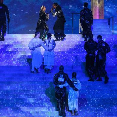 This handout photo released by KAN shows Madonna and US rapper Quavo performing during a guest appearance at the 64th edition of the Eurovision Song Contest 2019 at Expo Tel Aviv on May 19, 2019, in the Israeli coastal city of Tel Aviv. - Two of Madonnas dancers are pictured (foreground)  side-by-side with Israeli and Palestinian flags on their backs during her performance in an apparent call for unity. (Photo by Orit Pnini / KAN / AFP) / RESTRICTED TO EDITORIAL USE - MANDATORY CREDIT AFP PHOTO / KAN / ORIT PNINI   - NO MARKETING NO ADVERTISING CAMPAIGNS - DISTRIBUTED AS A SERVICE TO CLIENTS