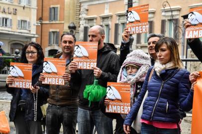 Italian members of the support committee of French quadriplegic Vincent Lambert, hold a banner reading #Im Vincent Lambert as they protest in front of Montecitorio, the Italian Parliament, in central Rome, on May 20, 2019. - Vincent Lambert, a quadriplegic man who has been in a vegetative state for the last decade, currently in Sebastopol hospital where doctors began switching off the life support. The dispute over the fate of Vincent Lambert has split his own family and even become a subject of political tension in France ahead of the weekends European elections. (Photo by Andreas SOLARO / AFP)