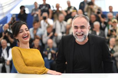 Brazilian actress Julia Stockler (L) and Brazilian film director Karim Ainouz laugh during a photocall for the film A Vida Invisivel de Euridice Gusmao (The Invisible Life of Euridice Gusmao) at the 72nd edition of the Cannes Film Festival in Cannes, southern France, on May 20, 2019. (Photo by LOIC VENANCE / AFP)