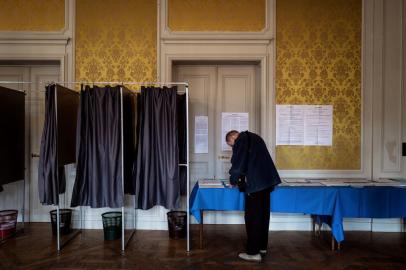 A person gets ready to cast his ballot during the vote for the European parliament elections, on May 26, 2019 in Le Puy-en-Velay. (Photo by JEFF PACHOUD / AFP)