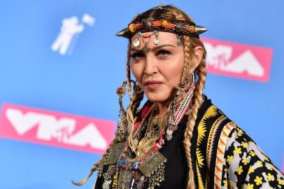 (FILES) In this file photo taken on August 21, 2018 Madonna poses in the press room at the 2018 MTV Video Music Awards at Radio City Music Hall in New York City. - Pop icon Madonna said she felt raped by an in-depth profile of her in The New York Times, calling the newspaper one of the founding fathers of the patriarchy. The New York Times article entitled Madonna at Sixty focused too much on her age, Madonna said, arguing it would not have done so were she a man.The journalist who wrote this article spent days and hours and months with me and was invited into a world which many people dont get to see, but chose to focus on trivial and superficial matters such as the ethnicity of my stand in or the fabric of my curtains and never ending comments about my age which would never have been mentioned had I been a MAN! Madonna said on her Instagram account. (Photo by ANGELA WEISS / AFP)