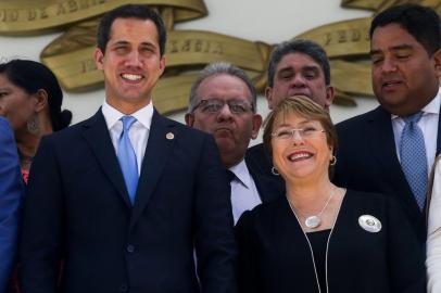 Venezuelan opposition leader and self-proclaimed interim president Juan Guaido (L) stands next to Chilean High Commissioner for Human Rights Michelle Bachelet (R) in Caracas on June 21, 2019. - Bachelet arrived in Venezuela Wednesday as part of a visit to review the countrys ongoing economic and political crisis. (Photo by CRISTIAN HERNANDEZ / AFP)