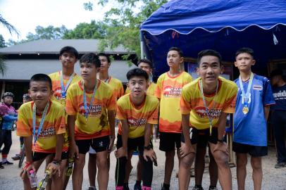 Members of the "Wild Boars" football team and their coach pose at the visitor centre for the Tham Luang cave, where the 12 boys and their coach were trapped last year, before participating in a marathon in the Mae Sai district of Chiang Rai province. The Thai cave boys and their football coach strapped on running shoes for a charity race that drew thousands on June 23, exactly one year after the youngsters entered the Tham Luang complex where they remained trapped for 18 nail-biting days.