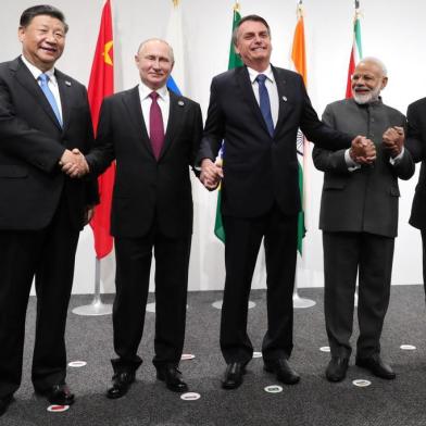  (From left) Chinese President Xi Jinping, Russian President Vladimir Putin, Brazilian President Jair Bolsonaro, Indias Prime Minister Narendra Modi and South African President Cyril Ramaphosa shake hands as they pose during a BRICS summit meeting at the G20 summit in Osaka on June 28, 2019. (Photo by Mikhail KLIMENTYEV / AFP)Editoria: POLLocal: OsakaIndexador: MIKHAIL KLIMENTYEVSecao: diplomacyFonte: AFPFotógrafo: STR