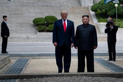 US President Donald Trump and North Koreas leader Kim Jong-un stand on North Korean soil while walking to South Korea in the Demilitarized Zone(DMZ) on June 30, 2019, in Panmunjom, Korea. (Photo by Brendan Smialowski / AFP)