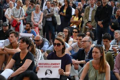 People pray for Vincent Lambert, who is in a vegetative state since 2008, in front of the Saint-Sulpice church in Paris on July 10, 2019. - Vincent Lambert, 42, has been in a vegetative state since a 2008 traffic accident, but the question of whether to continue keeping him alive artificially has bitterly divided his family and the nation. Doctors said on July 2, 2019 they will begin ending life support treatment. (Photo by Dominique FAGET / AFP)