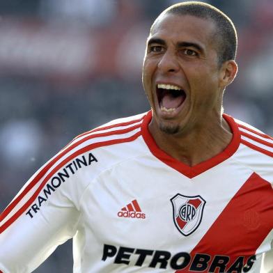 River Plates forward David Trezeguet celebrates with teammates after scoring the teams first goal against Almirante Brown during their Argentine Second Division football match, at the Monumental stadium in Buenos Aires, Argentina, on June 23, 2012.  AFP PHOTO / Alejandro PAGNI